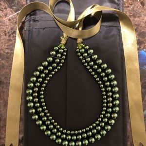 Green beaded necklace with ribbon tie.